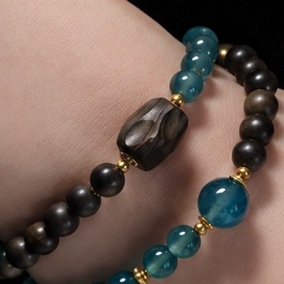 One dark bead with an uneven outline